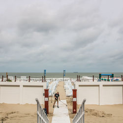 People on beach against sky