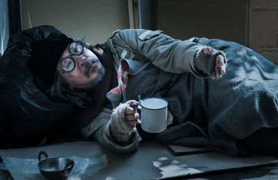 Midsection of man lying down at home