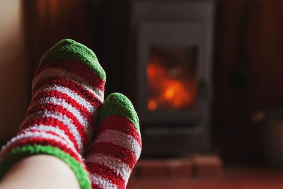 Low section of person wearing canvas shoes at home