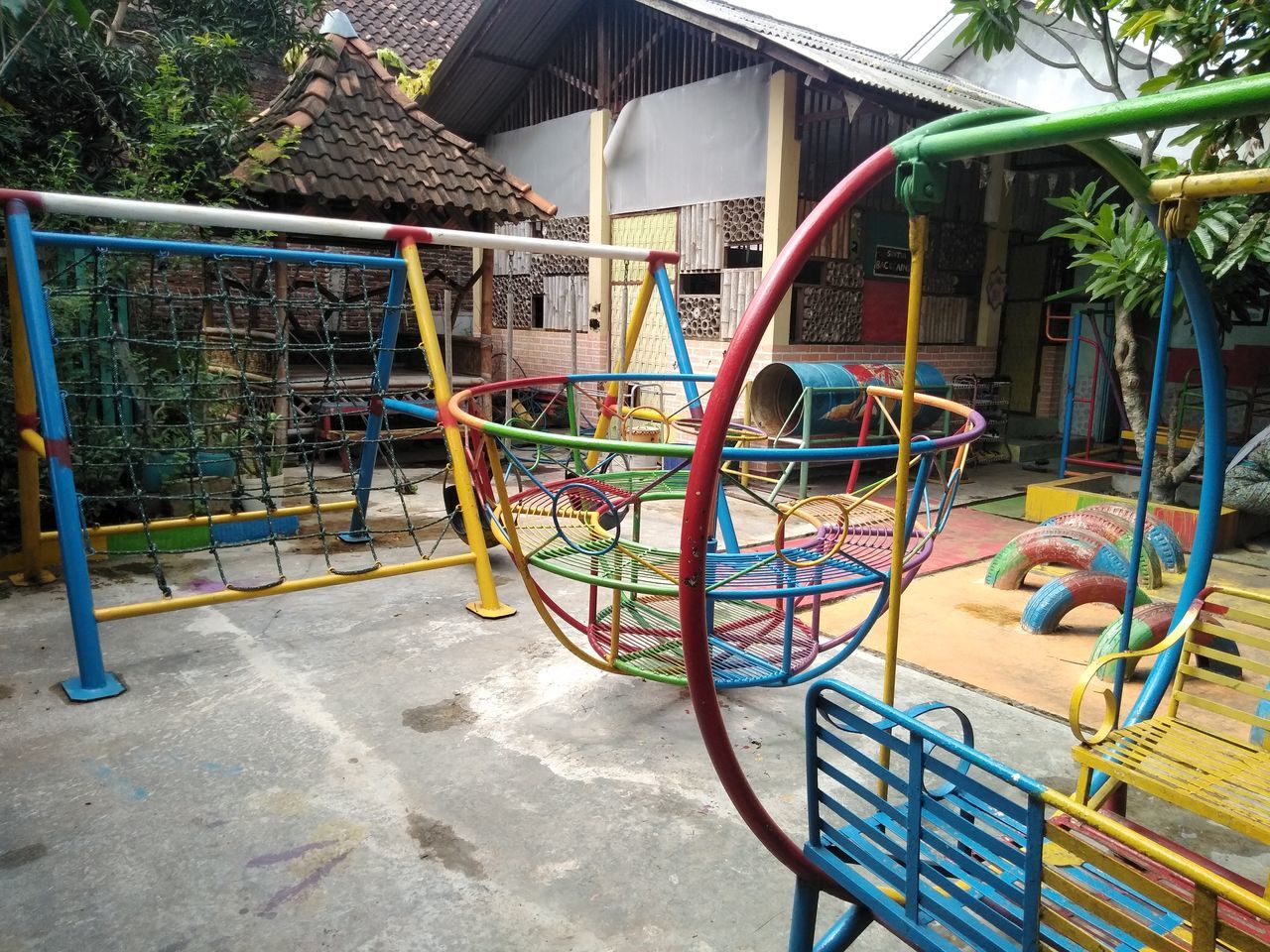 VIEW OF PLAYGROUND AGAINST BUILDINGS