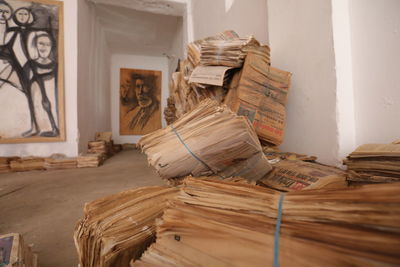 Stack of books on table against wall at home