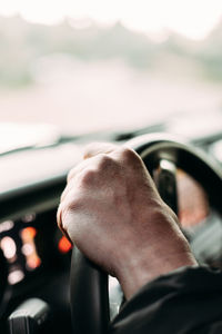 Midsection of man in car