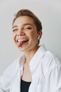 Portrait of young woman against white background