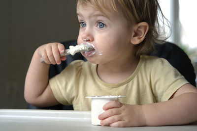 Close-up of boy eating food at home