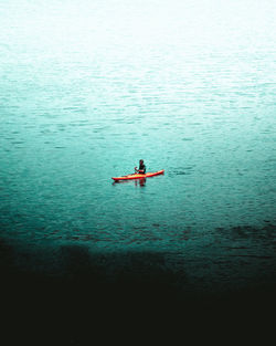 Man rowing boat in sea