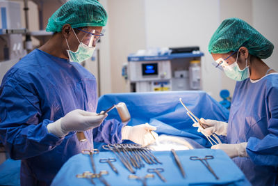 Surgeons operating patient in hospital