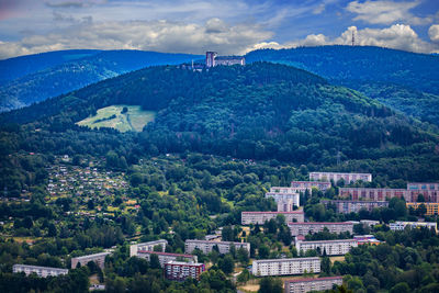 High angle view of townscape by mountain against sky