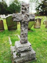 Close-up of cross in cemetery