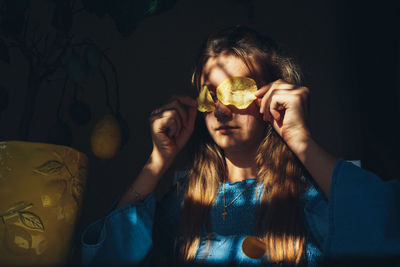 Portrait of woman holding ice cream at home