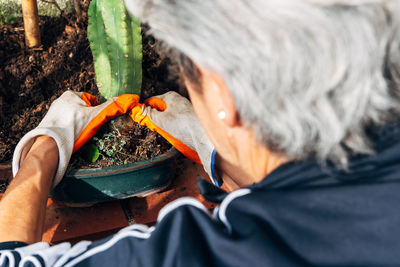 Close-up of man holding orange leaf