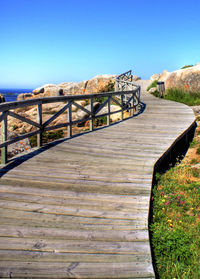 View of footbridge against clear sky