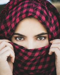 Close-up portrait of woman covering face