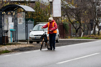 Man riding bicycle on road during rainy season