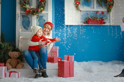 Portrait of smiling boy playing with christmas tree
