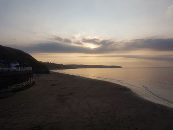 Scenic view of beach against sky during sunset