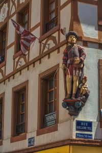 Low angle view of statue against building