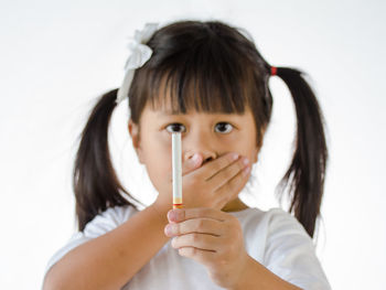 Close-up portrait of a girl holding white background