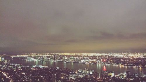 River in city against cloudy sky