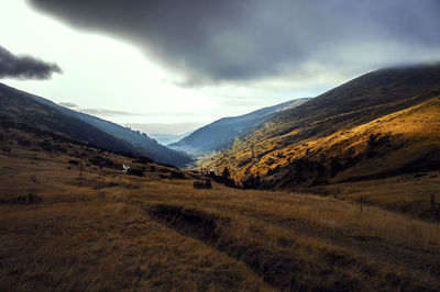 Scenic view of mountains against cloudy sky