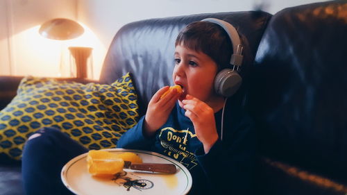 Boy eating food on table