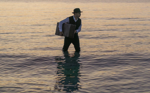 Full length of man standing in sea