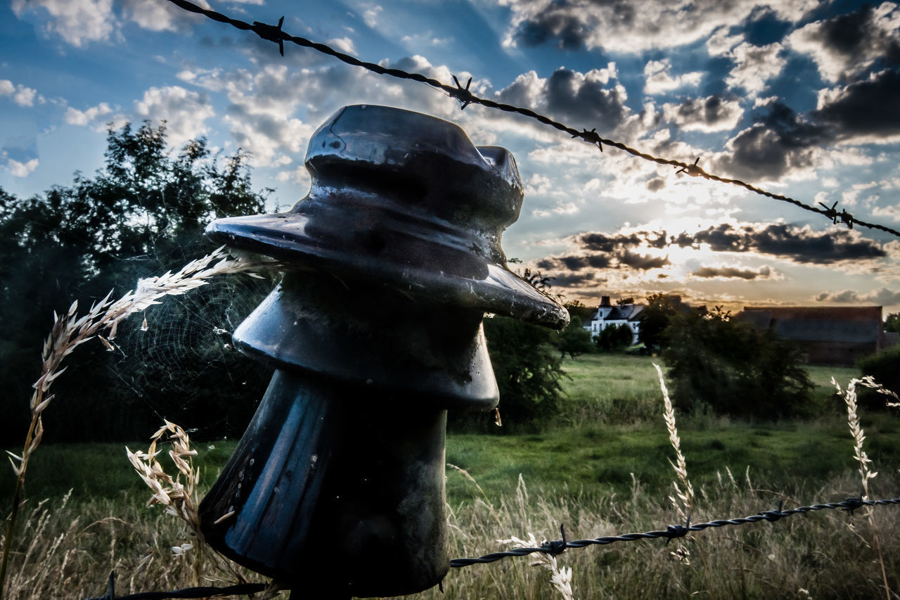 LOW ANGLE VIEW OF METAL FENCE ON FIELD