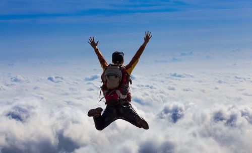 Man jumping against sky