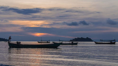 Koh rong island, cambodia at sunrise. strong vibrant colors, boats and ocean