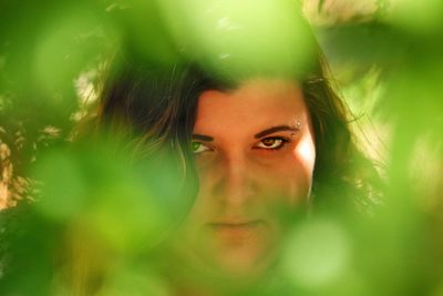 Close-up portrait of woman amidst branches