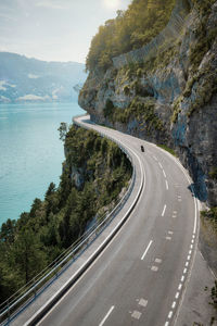 High angle view of road amidst trees against sky