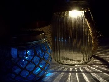 Close-up of illuminated lamp on table