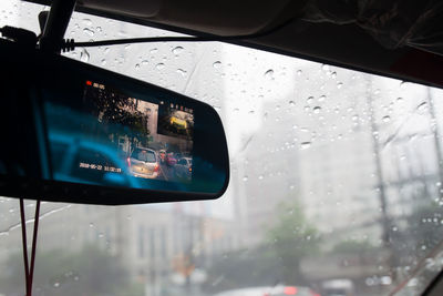 Reflection of car on wet window in rainy season