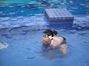 High angle view of woman wearing flower in swimming pool