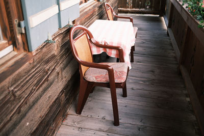 Plastic chair on old wooden balcony