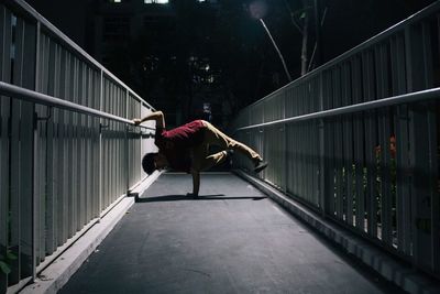 Full length of woman standing on railing