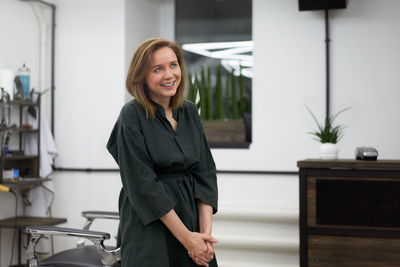 Beautiful woman hairdresser in modern barbershop 