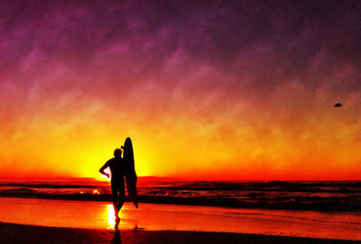 Silhouette of people on beach during sunset