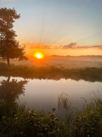 Scenic view of lake against sky during sunset