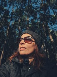 Portrait of man wearing sunglasses against trees