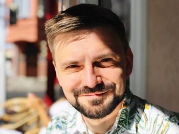 Close-up portrait of man smiling outdoors