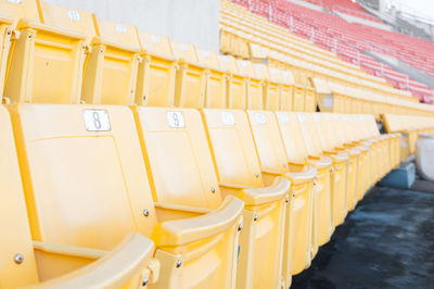 Empty yellow seats at stadium,rows of seat on a soccer stadium,select focus