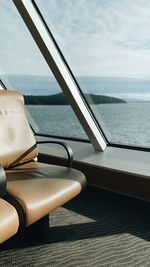 Close-up of table by sea against sky