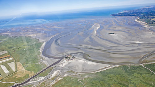 High angle view of land and mountains against sky