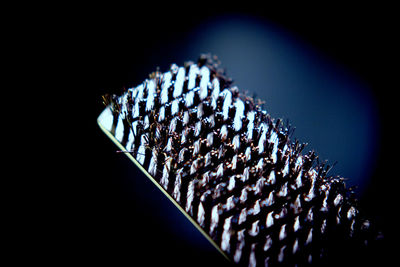 Close-up of colored pencils over black background