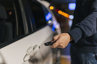 Businessman unlocking car door through key