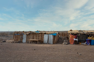 Clothes drying on beach against sky