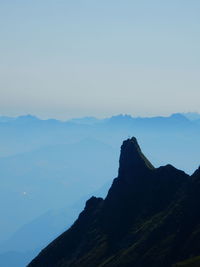 Scenic view of mountains against clear blue sky