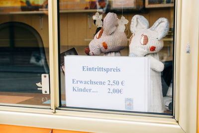 Stuffed toys with price label seen through store window