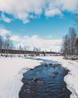 Frozen lake against sky during winter