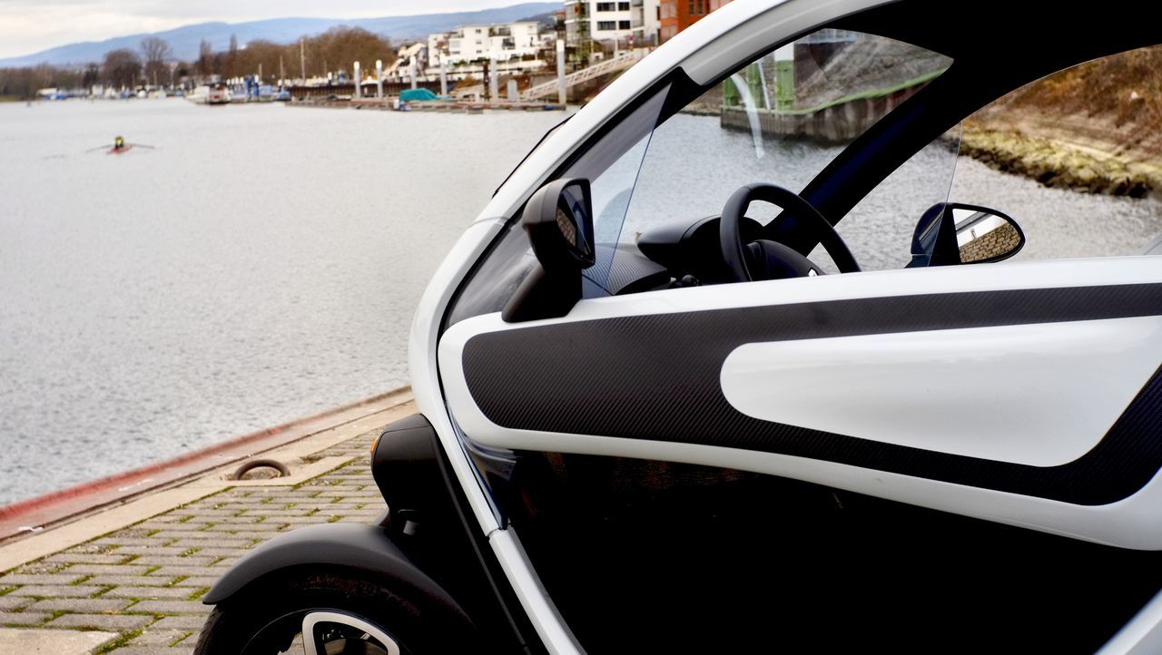 CLOSE-UP OF CAR SIDE-VIEW MIRROR